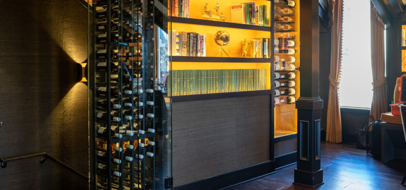 Overlooking a wine case and a selection of books.